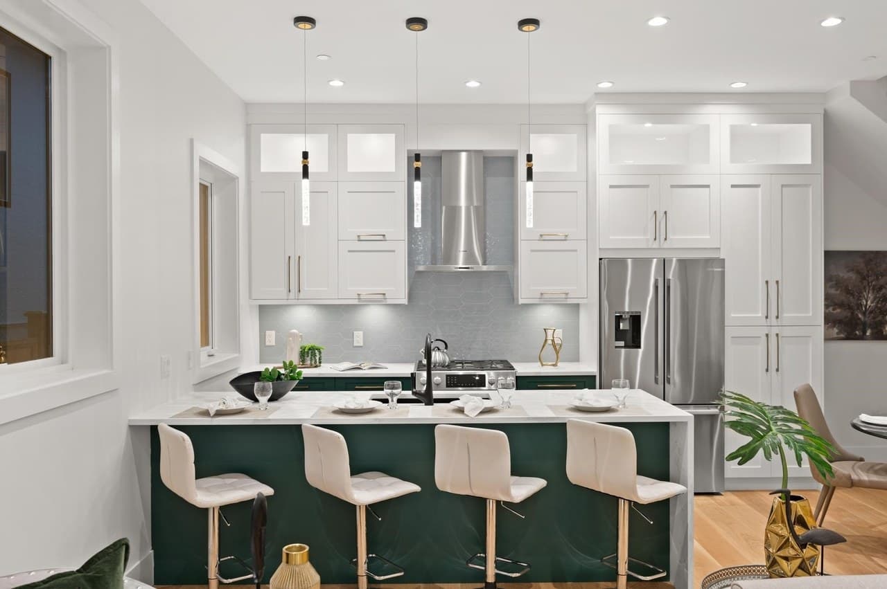The demonstration home’s kitchen with green cabinetry